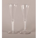 A PAIR OF GEORGE III FUNNEL SHAPED ALE GLASSES with double air twist stems, domed folded feet,