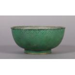 A CHINESE GREEN CLOISONNE ENAMEL CIRCULAR FOOTED BOWL, the exterior with graduated scaling beneath a