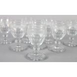 A SET OF NINE PORT GLASSES, diamond cut band above a slice cut bowl, knopped stem and circular foot