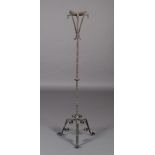 AN ARTS AND CRAFTS WROUGHT IRON CANDLESTAND with broad frilled drip pan supported on four animal