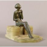 AN ART DECO GREEN PATINATED BRONZE FIGURE MOUNTED DESK STANDISH, the figure of a girl smoking a