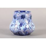 A WILLIAM MOORCROFT HESPERIAN DAISY design vase c.1902, tubelined and painted in shades of blue on a