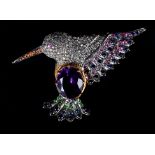 A HUMMINGBIRD BROOCH c.1950, the principal oval faceted amethyst claw set to the breast, the