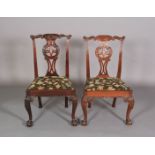 TWO 18TH CENTURY & LATER MAHOGANY DINING CHAIRS, each having serpentine top rail carved with leafage