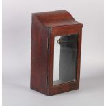 A MAHOGANY PORTABLE LANTERN CASE with shallow S-scroll top, the glazed door revealing plain
