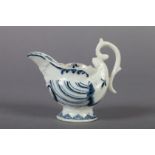 A DERBY BLUE AND WHITE PORCELAIN BUTTER BOAT c.1760 of moulded nautilus shape, the spout with