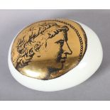 PIERO FORNASETTI (1913-1988) ITALY c.1950 an oval pebble-form paperweight printed in gilt and