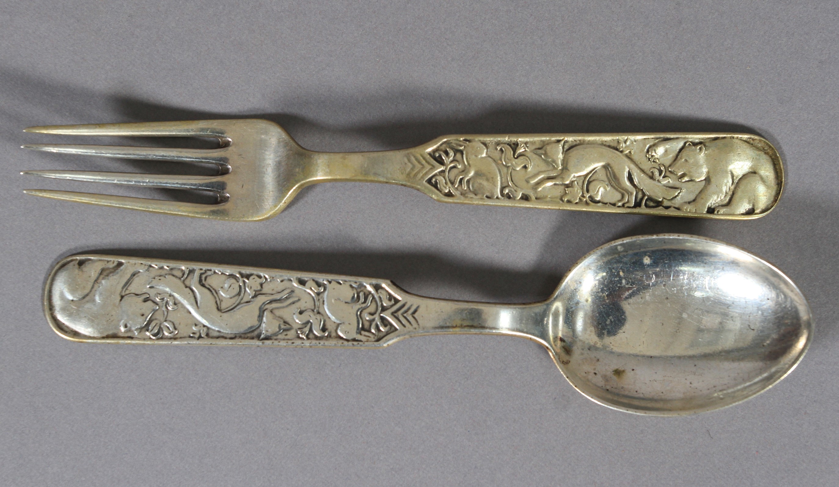 DAVID ANDERSEN, Norway, a child's .830 sterling silver spoon and fork set, each handle decorated
