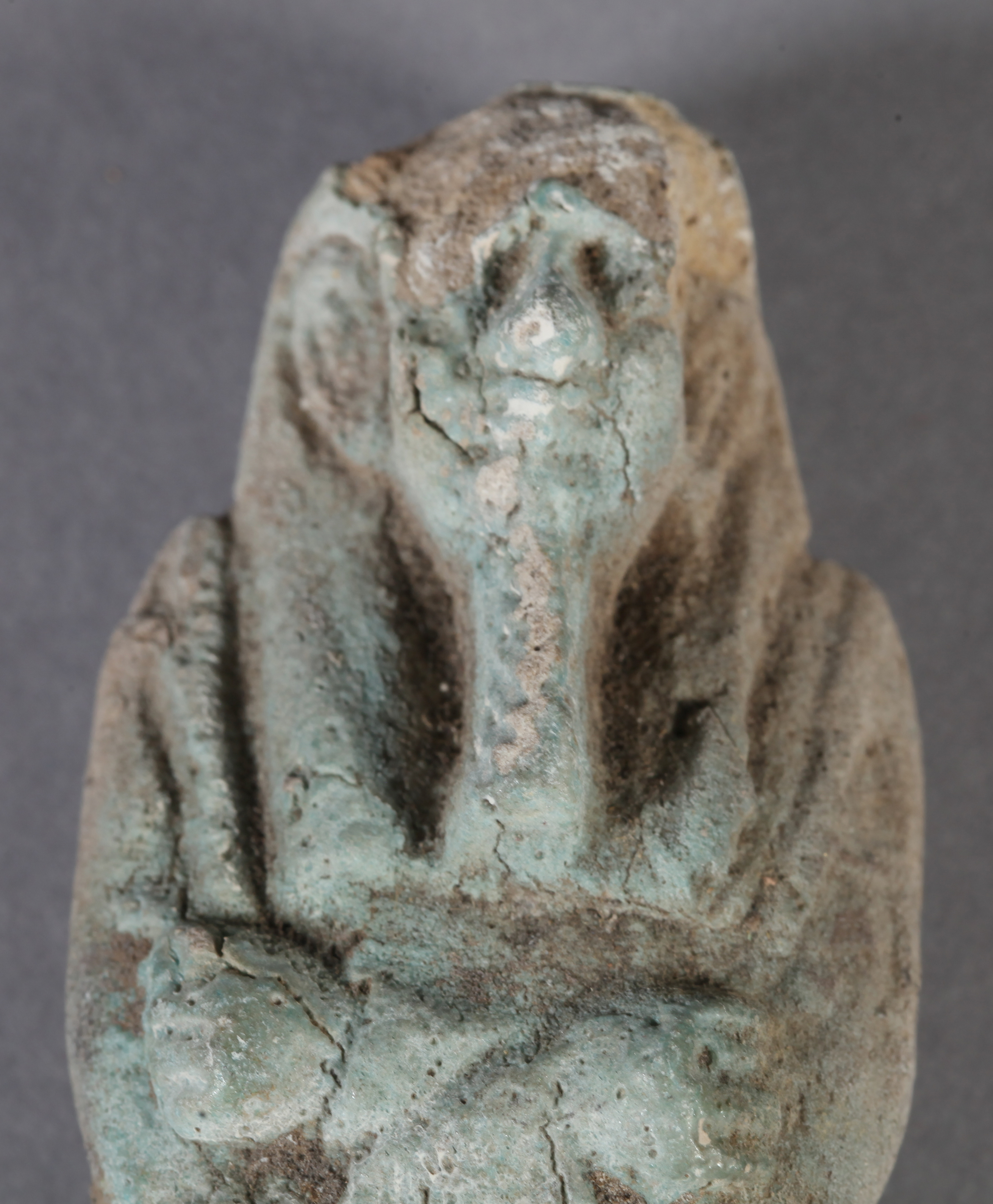 AN EGYPTIAN GLAZED POTTERY USHABTI possibly Osiris with arms crossed, carrying crook and flail, - Image 2 of 2