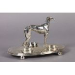 A VICTORIAN EPNS DESK STANDISH, the oval base mounted with figure of a greyhound, fitted for