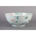 A CHINESE RIBBED CIRCULAR BOWL painted to the interior and exterior with flowers in coloured and