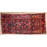 AN ANTIQUE PERSIAN HAND MADE BROJERD RUNNER, the black ground filled with geometric devices and