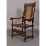 A CHARLES II STYLE WALNUT ARMCHAIR, 19th century, having a pierced cresting carved with pair of