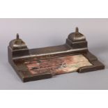AN ART DECO BRONZE AND VARIEGATED MARBLE INKSTAND, the lidded wells to each side with domed covers