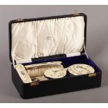 A GEORGE V FIVE PIECE SILVER GILT AND ENAMEL DRESSING TABLE SET each piece enamelled in green, blue,
