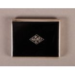 A SILVER AND BLACK ENAMEL VESTA CASE, the hinged front (sliding vertically to open) with