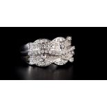 A DIAMOND SET RING IN 9CT WHITE GOLD the brilliant cut stones grain set to the writhen beaded