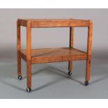 AN ALAN GRAINGER OF BRANDSBY 'ACORN MAN' ENGLISH OAK TWO TIER TROLLEY on square legs and castors,