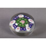 AN ANTIQUE CLICHY PAPERWEIGHT with green/pink central millefiore cane, flanked by border of green