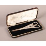 A GEORGE VI PAIR OF SILVER GRAPE SCISSORS, the handles cast with Bacchus face mask amidst grapevine,