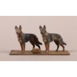 A COLD PAINTED GROUP OF ALSATIANS on an Eastern carpet, mounted with a small card holder, 15.5cm
