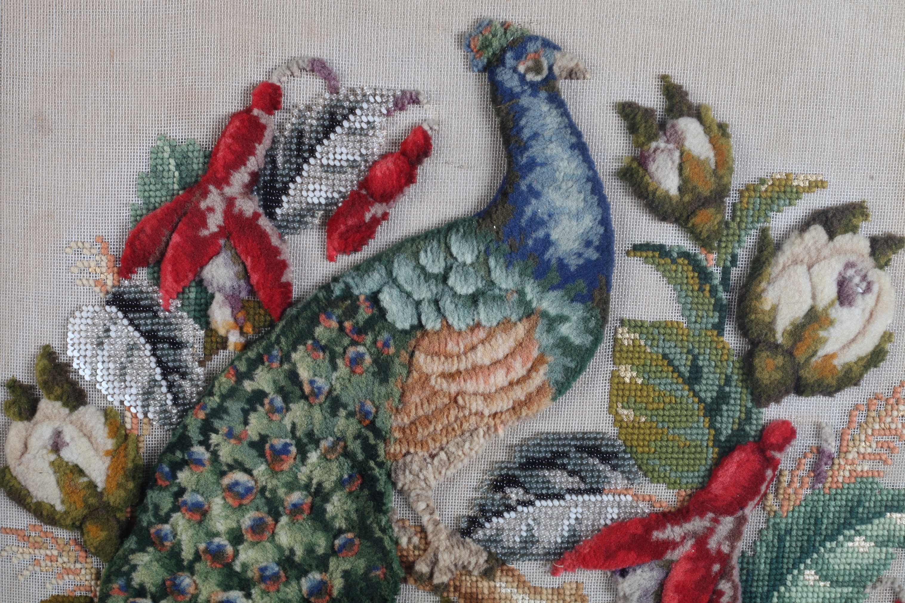 A VICTORIAN PLUSH WOOLWORK PICTURE with glass beadwork leaves of a peacock amidst flowers and - Image 2 of 2