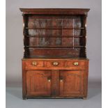 A 19TH CENTURY OAK DRESSER AND RACK having a moulded cornice, the frieze with pendant finials,