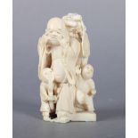 A LATE 19TH CENTURY JAPANESE IVORY OKIMONO OF BUDDHA pulling faces to amuse twin boys, signed to red