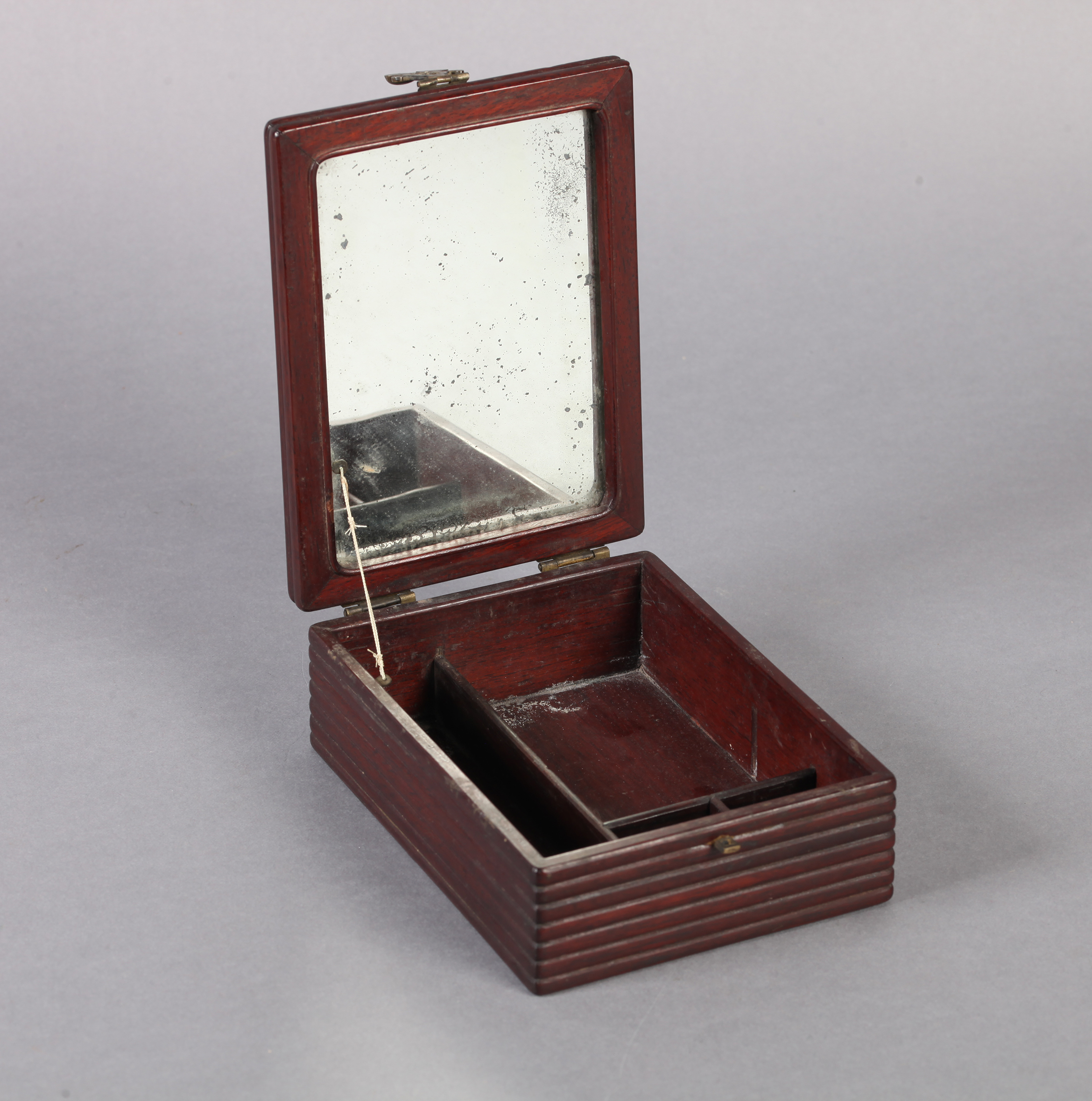 A CHINESE HARDWOOD DRESSING TABLE BOX of rectangular form, the hinged lid with ribbed edge, the body