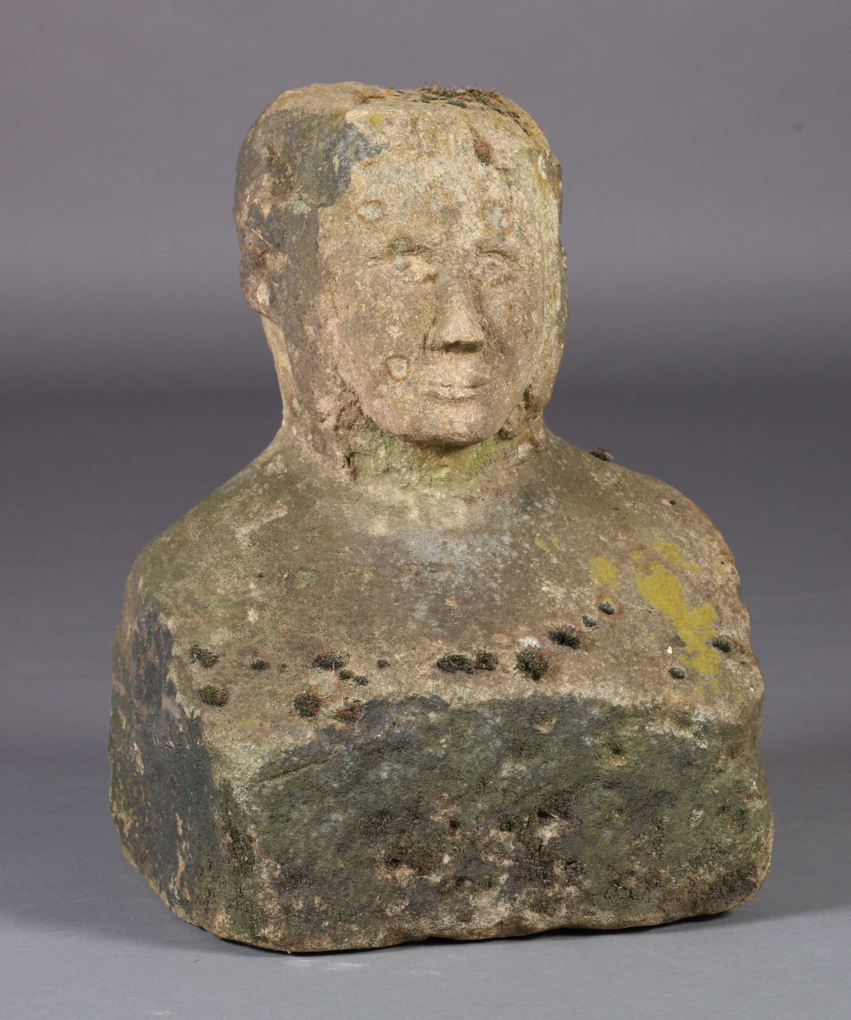 A 19TH CENTURY STONE SCULPTURE OF A MALE HEAD AND SHOULDERS the face re-carved, 40cm wide x 29cm