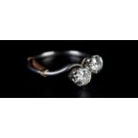 A TWO STONE DIAMOND RING IN PLATINUM c.1930 the brilliant cut stones claw set in a crossover