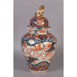 AN 18TH CENTURY IMARI PORCELAIN BALUSTER VASE AND COVER decorated in typical palette with birds