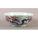 AN 18TH CENTURY CHINESE PORCELAIN FAMILLE ROSE BOWL, circular, the exterior painted with fruit laden