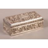A VICTORIAN EMBOSSED SILVER RECTANGULAR BOX AND COVER, the hinged lid with central initialled