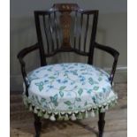 A late Victorian inlaid mahogany tub chair, the cresting rail detailed with cherubs and leafage