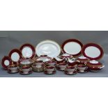 A Coalport dinner service bordered in maroon and gilt comprising consommé cups and saucers, plates