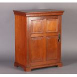 AN EDWARD VII WALNUT COIN CABINET enclosed by a four panelled door, projecting top and skirted base,