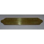A late Victorian brass scoring plate on four small feet, stamped to the underside 1899 30.5cm long x