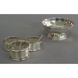 A circular sugar bowl, Sheffield 1941 and three various napkin rings, approximately 3.5oz