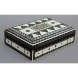 An ivory and mosaic inlaid box of geometric design, 18cm wide x 13cm deep x 4.5cm high, complete