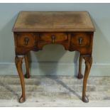 A reproduction burr walnut veneered lowboy , the top butterfly veneered within broad cross grained