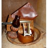 An Indian carved hardwood letter rack, a leather pouch bag, circular wooden bowl, a cream metal