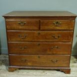 A 19th century mahogany chest of two short and three long graduated drawers, shaped bracket feet,