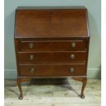 A reproduction mahogany bureau, the quarter veneered fall-flap above pair of slides and three long