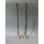 A pair of white metal open twist and baluster candlesticks on domed bases, 74.5cm high