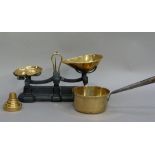 A set of brass and iron weighing scales, a set of weights and a brass sauce pan