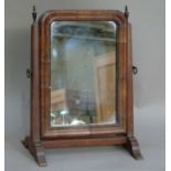 A dressing table mirror in early George III style the arched rectangular plate within cushion