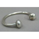 A torque bracelet in silver c.1970 with baluster terminals, approximate weight 36gm