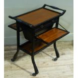 An Arts and Crafts ebonised oak work table, the tray top with moulded frame with turned handles
