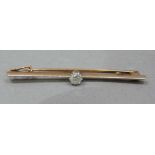 A George V single stone diamond bar brooch in 15ct rose gold with platinum facing, the Old
